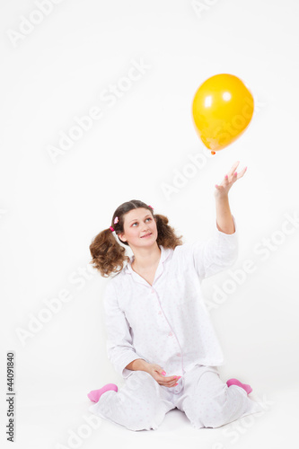 Photo: girl with a pajamas with multi-colored balloons girl with a pajamas with multi-colored balloons