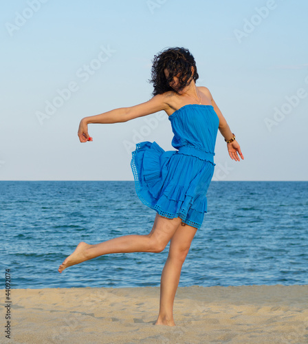 Photo: Woman posing on a sandy beach Woman posing on a sandy beach