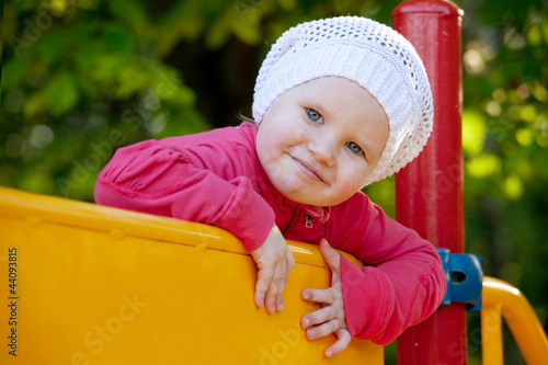Photo: Little girl playing on the playground Little girl playing on the playground