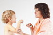 Young mother teaches her son to brush their teeth
