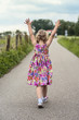 Photo: Walking toddler with her hands up in the air Walking toddler with her hands up in the air