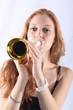 Pretty redhead woman playing the trumpet