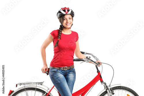 Photo: Smiling female posing next to a bicycle Smiling female posing next to a bicycle