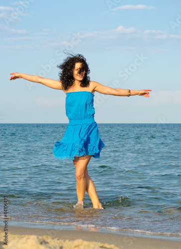 Photo: Woman dancing in the sea Woman dancing in the sea