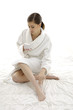 Confident, happy woman wearing bathrobe