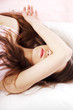 Photo : Sad woman is lying in bed with her arm on head and eyes. Sad woman is lying in bed with her arm on head and eyes.
