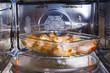 Chicken legs on a glass dish in the convection oven