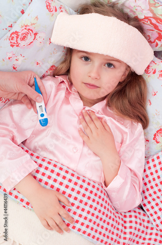 Photo: Cold and flu - child with fever in the bed Cold and flu - child with fever in the bed