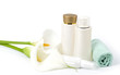 Beauty spa lotions, white calla and towel on white background