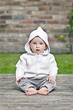 Pretty Baby Girl Sitting in Garden