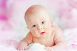 portrait of cute newborn baby on a pink bed