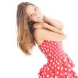 Happy carefree teenage girl in a trendy dot dress