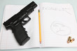 Automatic Pistol with loose ammunition & pencil on comp book
