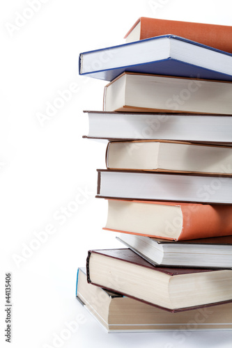 Photo: A stack of books on a white background. A stack of books on a white background.