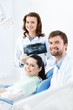 Dentist, assistant and client are satisfied of their work