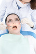 Dentist's assistant checks the teeth of the patient