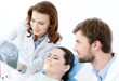 Patient thoroughly examines the x ray photo of her teeth