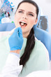 Dentist diagnoses the oral cavity of the patient