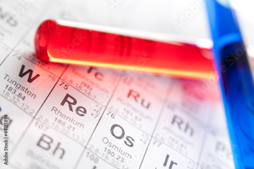 Photo: Two test tubes with colored reagents lying on the periodic table Two test tubes with colored reagents lying on the periodic table
