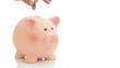 Saving money: hand putting coins in a piggy bank. Isolated