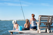 Mother and her two daughters fishing off an old wooden pier
