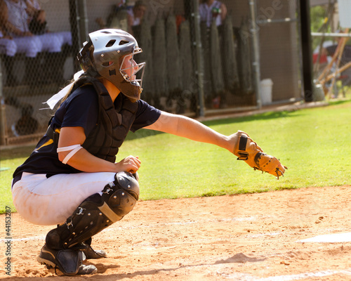 Photo: Young teen girl playing softball in organized game Young teen girl playing softball in organized game