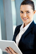beautiful young businesswoman with tablet computer in office