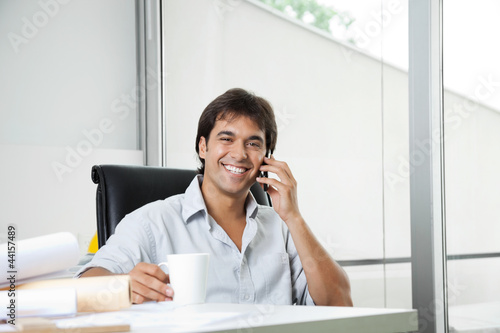 Photo: Happy Architect On Phone Call Happy Architect On Phone Call