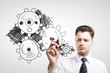 man drawing gears