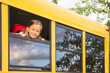 Little Schoolgirl looking through a Schoolbus Window