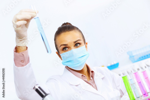 Photo: Young female scientist working in laboratory Young female scientist working in laboratory