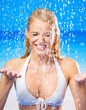 Foto: Young woman at rain or summer shower on beach Young woman at rain or summer shower on beach