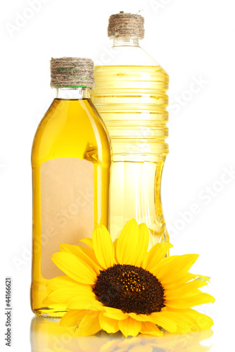 Photo: oil in jars and sunflower, isolated on white oil in jars and sunflower, isolated on white
