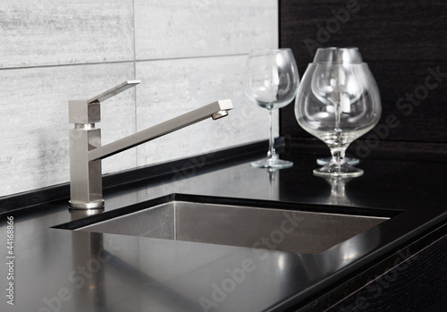 Photo: Modern kitchen sink with metal tap and black marble Modern kitchen sink with metal tap and black marble
