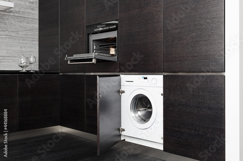 Photo: Build-in washing machine and cooker on modern black kitchen Build-in washing machine and cooker on modern black kitchen