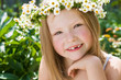 A pretty little girl in wreath of flowers