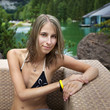 Young woman relaxing on the armchair II
