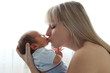 Photo: Mother kissing newborn Mother kissing newborn
