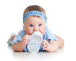 adorable child drinking from bottle. 8 months old girl.