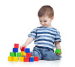 cheerful kid boy with construction set over white background