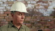 Engineer in front of old brick wall