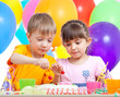 kids boy and girl eating cake on party birthday