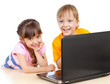 happy children boy and girl using a laptop
