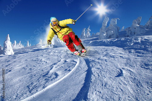 Photo: Skier skiing downhill in mountains Skier skiing downhill in mountains