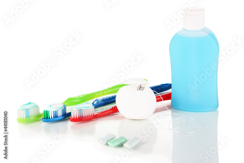 Photo: Toothbrush, chewing gum and dental floss isolated on white Toothbrush, chewing gum and dental floss isolated on white
