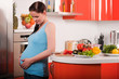 Photo: Pregnant woman in kitchen Pregnant woman in kitchen