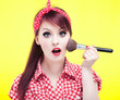 Photo: Cute pin up girl applying blusher Cute pin up girl applying blusher
