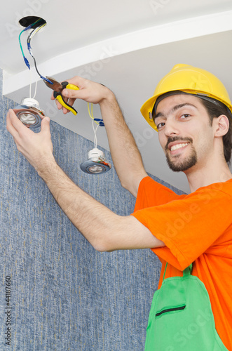 Photo: Electrician repairman working on refurbishment Electrician repairman working on refurbishment