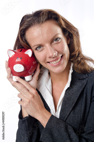 Photo: Woman with piggybank on white Woman with piggybank on white