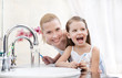 Photo: Little girl brushes her teeth with her mother Little girl brushes her teeth with her mother